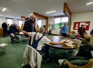 People talk to candidate Tom O'Donnell in the community room at St. Michael's Episcopal Church.