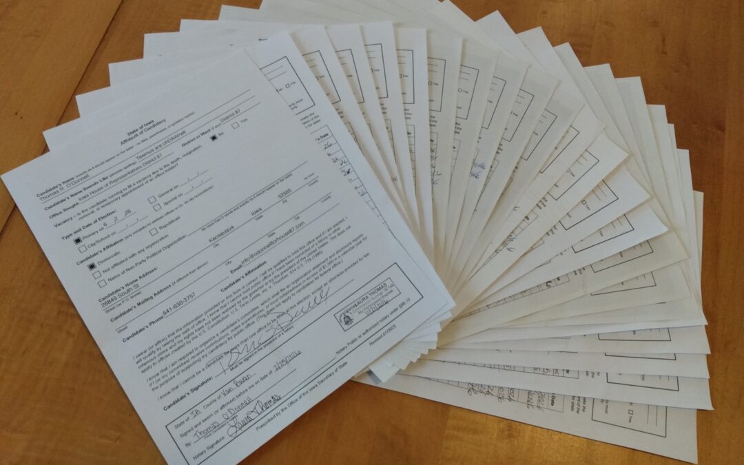 Papers fanned out on a wood table.