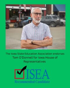 Tom O'Donnell in the Bonparte business district with the Iowa State Education Association logo